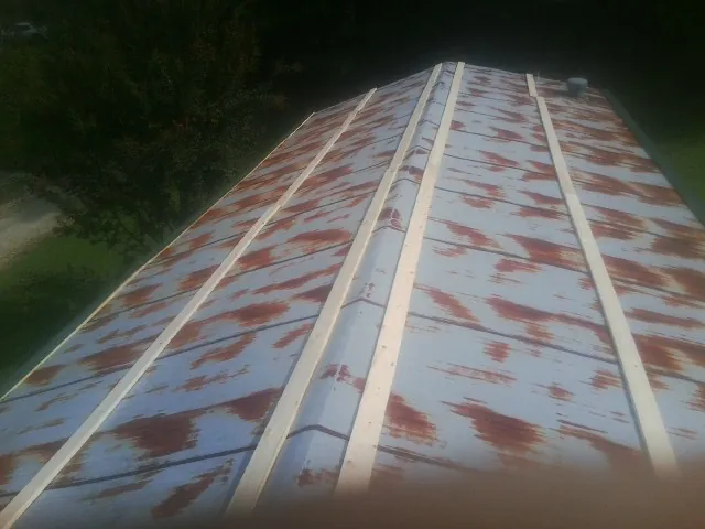 Rusted metal roof panels with new wood purlins before replacement — Storm Damage Roof Repair in Peapack by Roofing Brothers